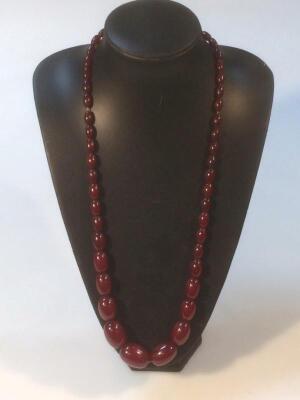 A string of graduated cherry amber beads