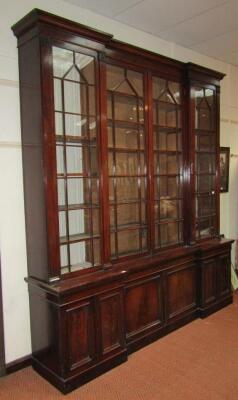 An early Victorian mahogany breakfront cabinet bookcase