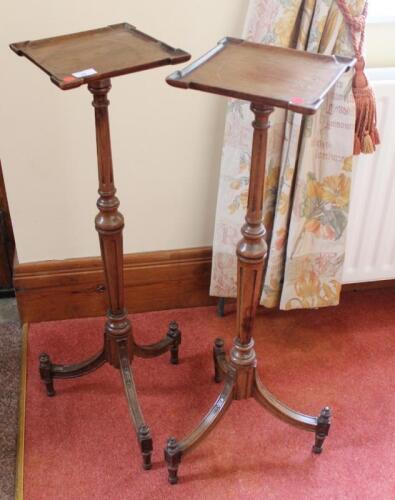 A pair of 19thC walnut candle stands