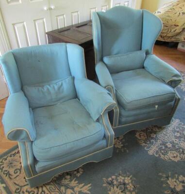 A pair of modern blue wing armchairs