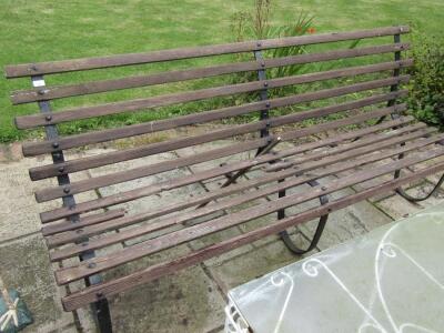 A Victorian style wrought iron garden bench