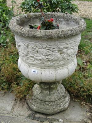 A pair of modern stone garden urns