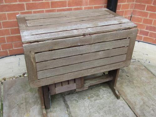 A hardwood folding garden table.