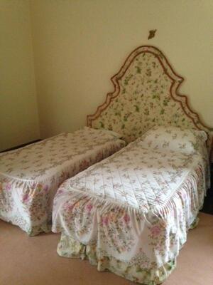 A floral headboard and double/twin single bed combination.