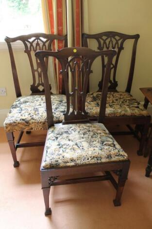 A harlequin group of three George III mahogany dining chairs