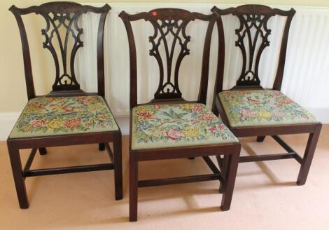 A set of three George III mahogany dining chairs