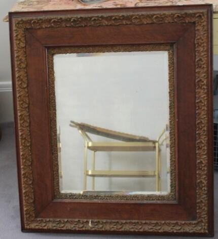 An Edwardian oak and gesso wall mirror