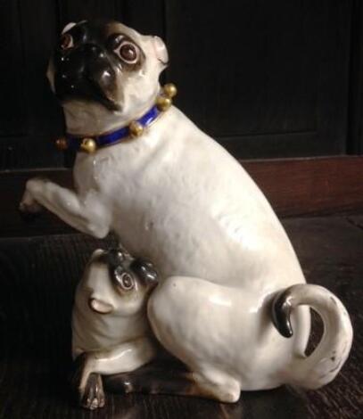 An 18thC Meissen porcelain figure group model of a pug and pup