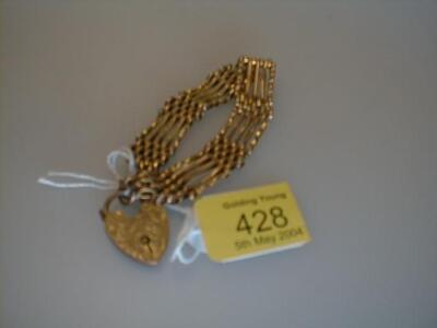 A yellow metal 5 bar gate bracelet with padlock clasp