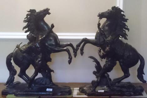 After Guillame Coustou. A pair of late 19thC bronze Marley groups of horses with attendants in the t