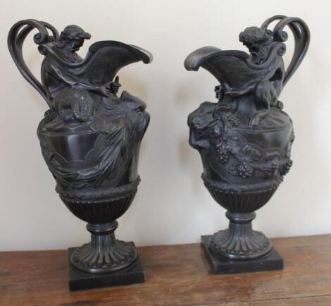 A pair of 19thC French bronze ewers