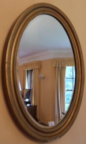 A late Victorian oval gilt framed wall mirror