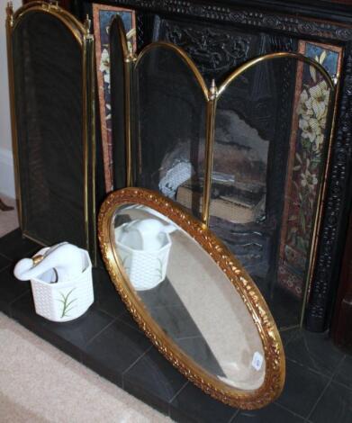 An oval gilt framed mirror