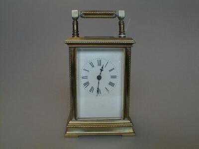 A gilt brass carriage time piece 6" high