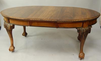 A reproduction mahogany oval extending dining table