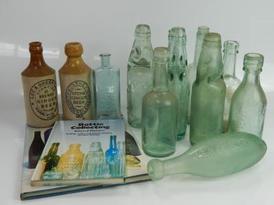 A collection of vintage glass and stoneware bottles