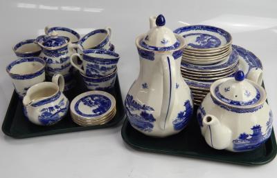 A Ringtons blue and white willow pattern part dinner