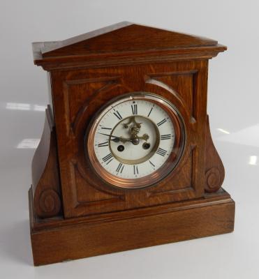 A late Victorian oak mantel clock