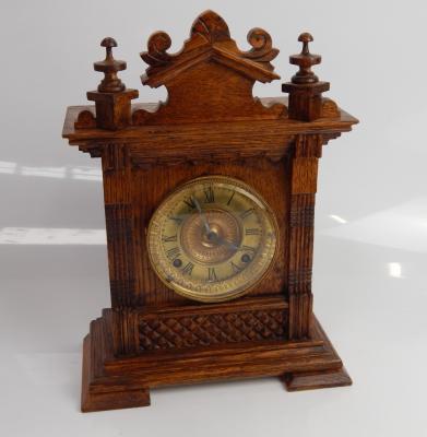 A late Victorian German oak mantel clock