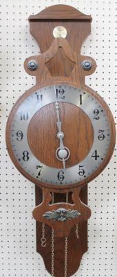 A modern oak cased wall clock