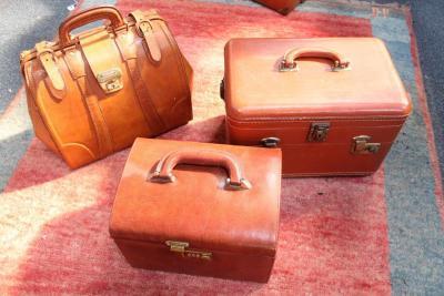 Three small vintage travel cases.