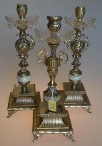 A pair of gilt metal, onyx and glass table lustre candlesticks, cast with