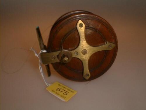 An early 20th century mahogany and brass fishing reel