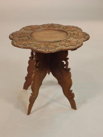 An eastern carved teak occasional table