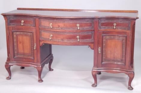 An Edwardian mahogany serpentine fronted sideboard