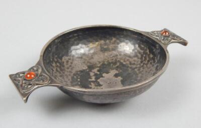 An Edwardian hammered silver Arts and Crafts style quaich by Sybil Dunlop