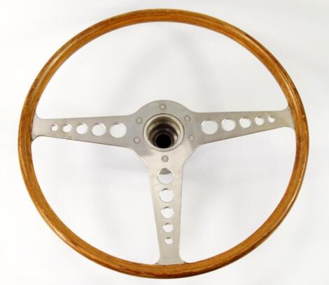 A period wooden and alloy steering wheel for an E-type Jaguar.
