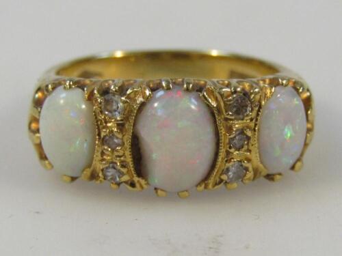 A ladies three stone opal ring