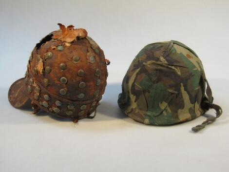 An unusual metal peaked helmet