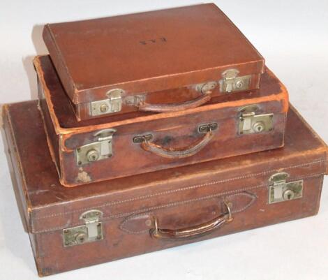 An early 20thC pressed brown leather travelling case