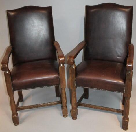 A pair of 20thC oak framed carver chairs