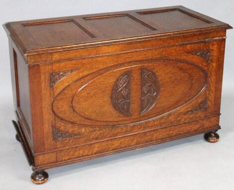 A 20thC oak Jacobean style three panelled coffer