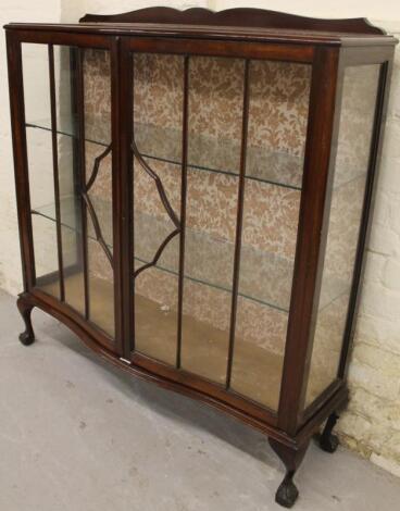 A mid-20thC mahogany finish serpentine fronted display cabinet