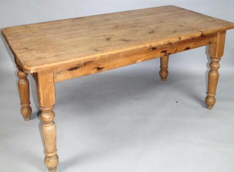 An early 20thC stripped and lightly polished pine kitchen table