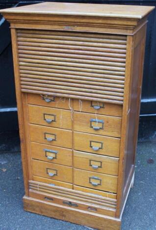 A mid-20thC oak tambour fronted cabinet