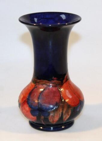 A mid-20thC Moorcroft flambe Wisteria pattern vase