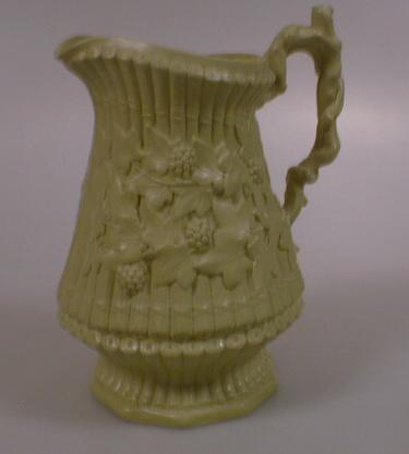 A Victorian drabware jug moulded with rustic handle and bamboo body embellished