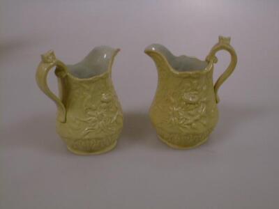 A pair of Victorian drabware jugs moulded with loop handle and