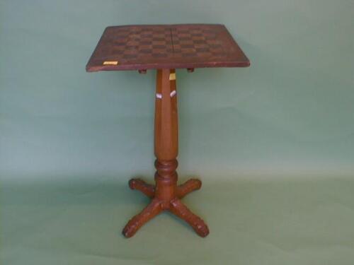 A chess board table, supported on a panelled column and cruciform base, 18" square