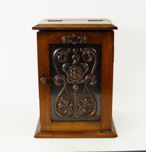 An Edwardian oak smokers cabinet