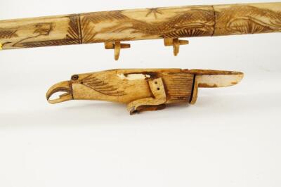 A decorative carved bone blow pipe - 2