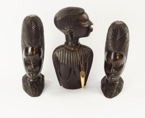 A pair of African carved ebony female heads