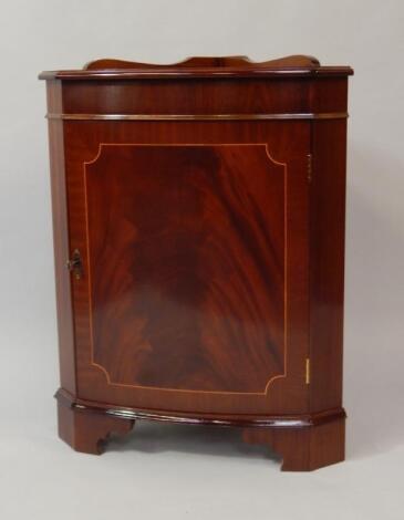 A Georgian style reproduction mahogany standing corner cupboard