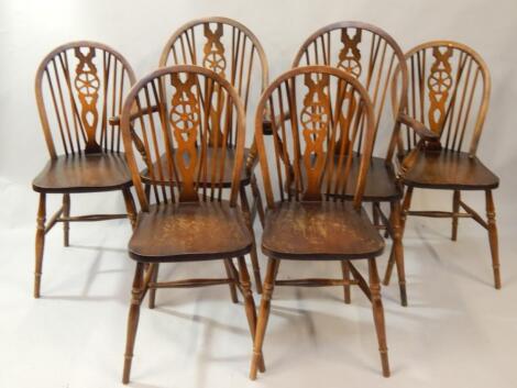 A set of six beech wheelback dining chairs