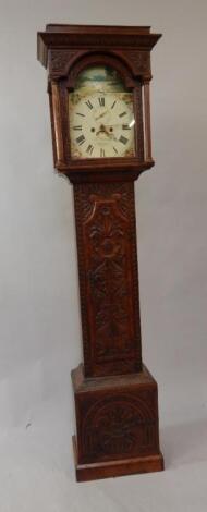 A carved oak longcase clock