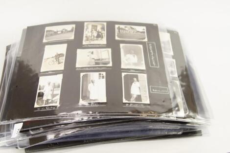 A quantity of mounted black and white photographs to include half length portraits